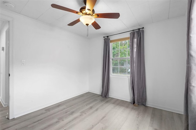 3616 Stardust Pl, Sarasota, FL 34232 - empty room featuring light wood finished floors, ceiling fan, a smoke detector, and baseboards