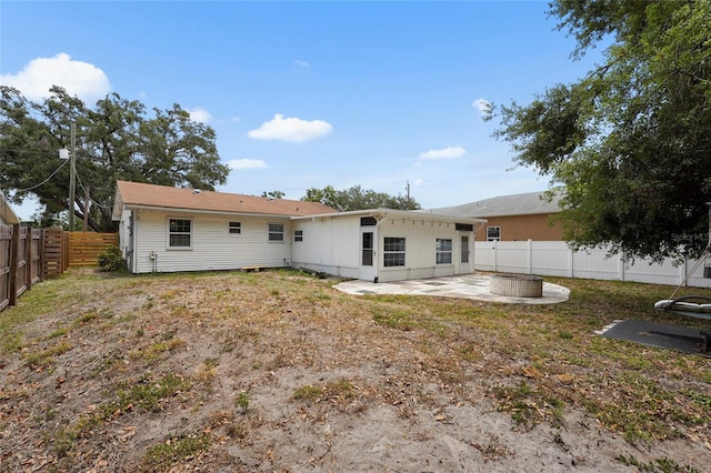 3616 Stardust Pl, Sarasota, FL 34232 - rear view of house with a patio area, a fenced backyard, and an outdoor fire pit