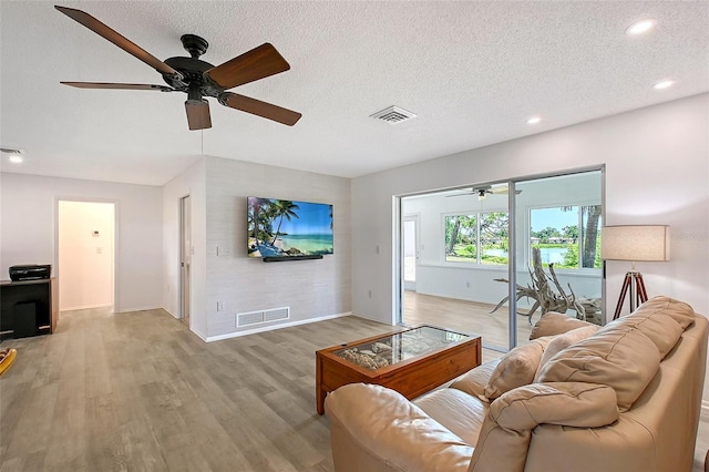415 Courbet Dr Unit 415, Nokomis, FL 34275 - living room with a ceiling fan, light wood-style floors, baseboards, recessed lighting, and a textured ceiling