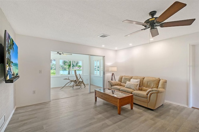 415 Courbet Dr Unit 415, Nokomis, FL 34275 - living area with ceiling fan, light wood-style floors, recessed lighting, a textured ceiling, and baseboards