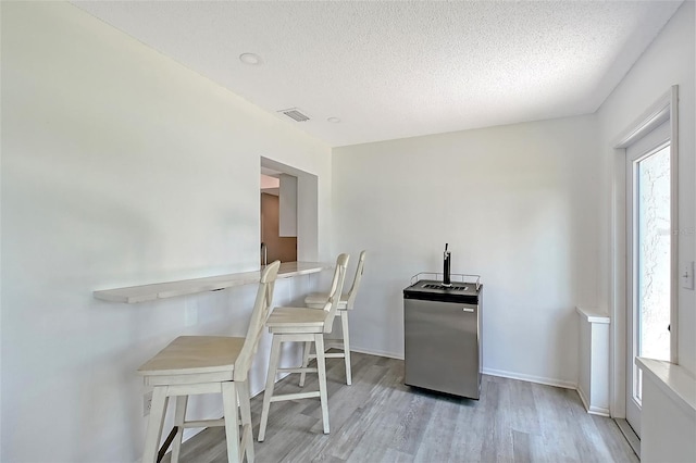415 Courbet Dr Unit 415, Nokomis, FL 34275 - dining space featuring wood finished floors, a textured ceiling, and baseboards