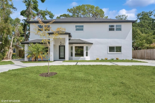 2655 Bay St, Sarasota, FL 34237 - view of front of house featuring a front yard, stucco siding, and fence