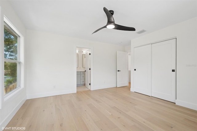 2655 Bay St, Sarasota, FL 34237 - unfurnished bedroom featuring light wood-style flooring, baseboards, and a closet