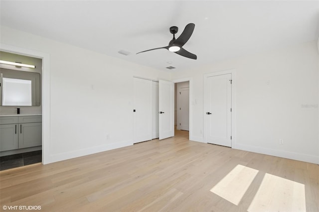2655 Bay St, Sarasota, FL 34237 - unfurnished bedroom featuring baseboards, ensuite bathroom, visible vents, two closets, and light wood-type flooring