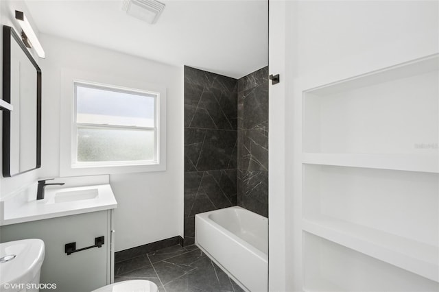 2655 Bay St, Sarasota, FL 34237 - full bath with marble look tiles, toilet, baseboards, vanity, and shower / bathtub combination