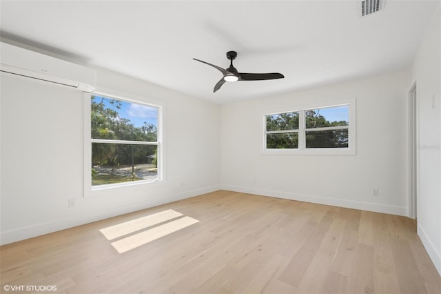 2655 Bay St, Sarasota, FL 34237 - unfurnished room with a wall mounted air conditioner, visible vents, light wood-style flooring, and baseboards
