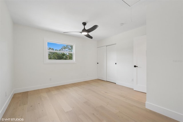 2655 Bay St, Sarasota, FL 34237 - unfurnished bedroom with a closet, attic access, baseboards, ceiling fan, and light wood-style floors