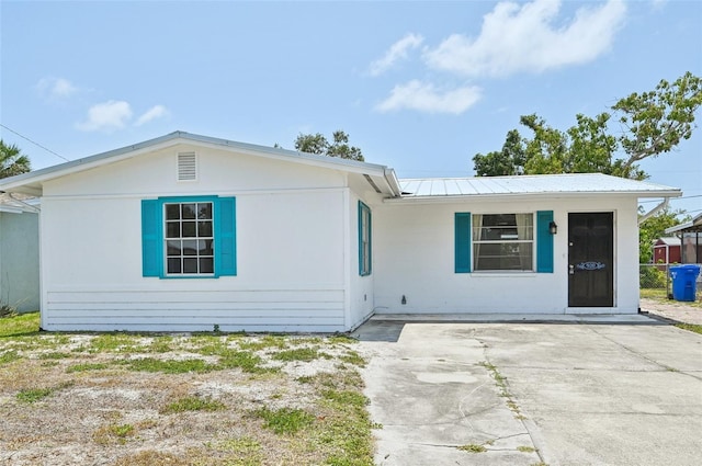 single story home featuring metal roof