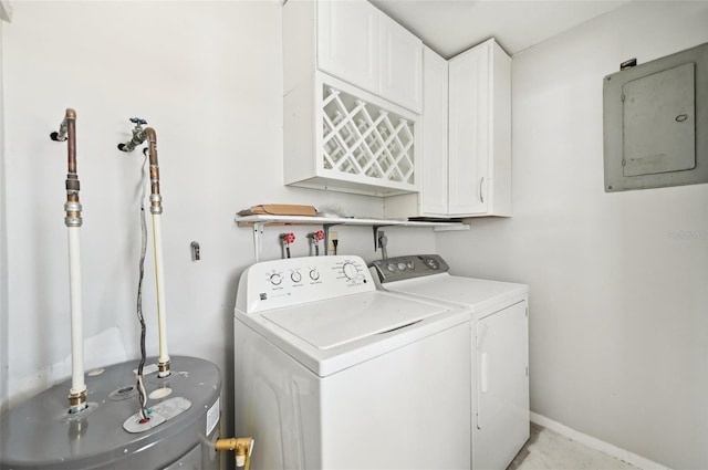 clothes washing area featuring electric panel, cabinet space, washer and clothes dryer, and water heater