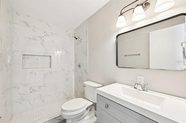 full bathroom featuring vanity, a marble finish shower, and toilet