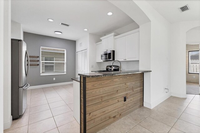 4315 Deep Creek Ter, Parrish, FL 34219 - kitchen featuring appliances with stainless steel finishes, arched walkways, light tile patterned floors, and recessed lighting