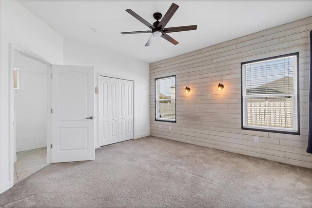 4315 Deep Creek Ter, Parrish, FL 34219 - unfurnished bedroom featuring wooden walls, carpet flooring, a closet, and a ceiling fan