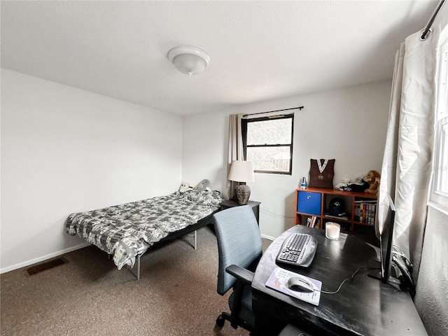 bedroom featuring baseboards, a desk, and carpet flooring