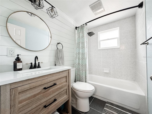 bathroom featuring shower / tub combo, tile patterned flooring, toilet, and vanity