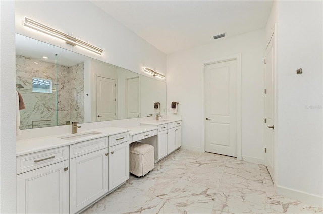 full bath with a marble finish shower, vanity, baseboards, and marble look tiles