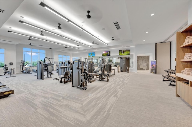 exercise room featuring light colored carpet and ceiling fan