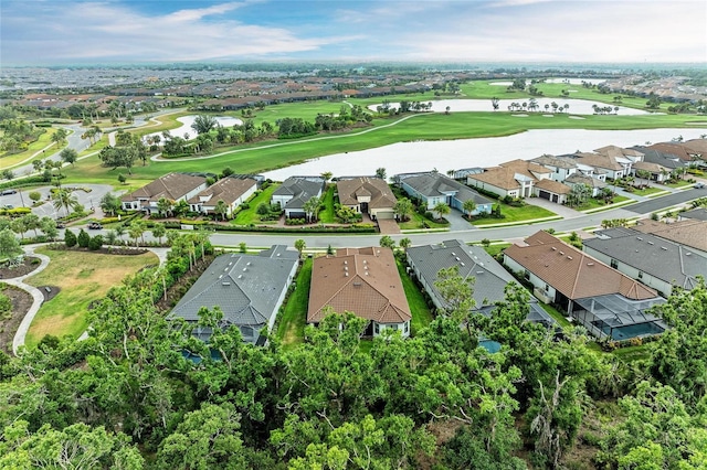 aerial view of residential area featuring a large body of water and a local golf course