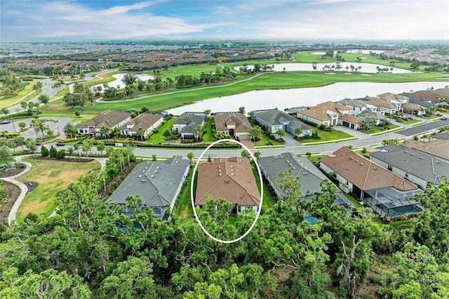 aerial perspective of suburban area featuring a nearby body of water and a local golf course