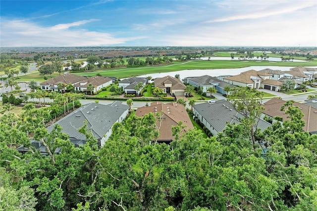 aerial view of residential area with a golf course and a nearby body of water