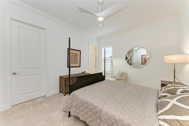 bedroom with carpet, ornamental molding, and a ceiling fan