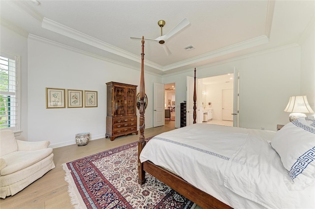 bedroom featuring light wood-type flooring, crown molding, connected bathroom, ceiling fan, and baseboards