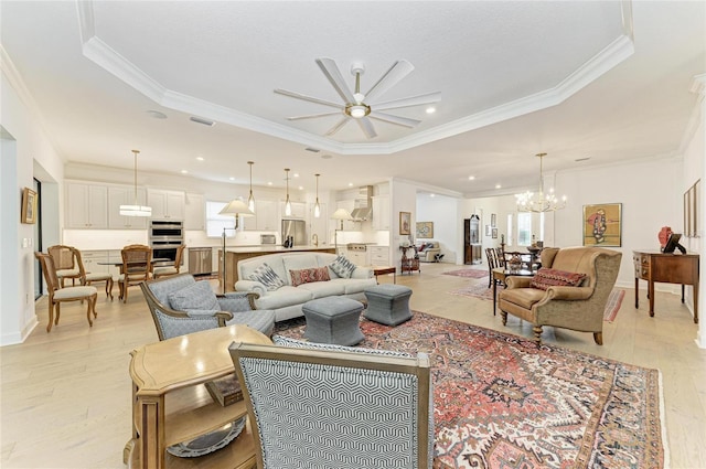 living area featuring crown molding, a ceiling fan, light wood finished floors, a chandelier, and baseboards