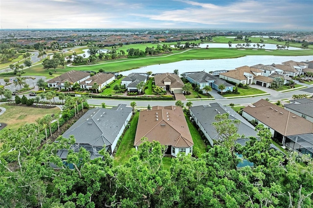 aerial perspective of suburban area with a golf club and a large body of water