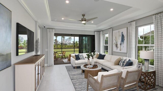 living room with a raised ceiling, ceiling fan, recessed lighting, crown molding, and light tile patterned floors