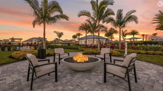 view of patio / terrace with an outdoor fire pit and fence