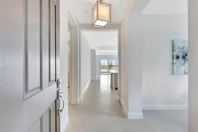 entryway featuring light tile patterned flooring and baseboards