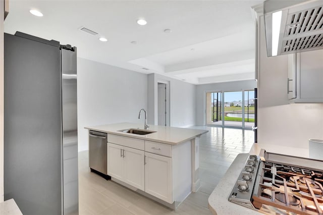 kitchen featuring stainless steel appliances, a sink, light countertops, white cabinetry, and recessed lighting