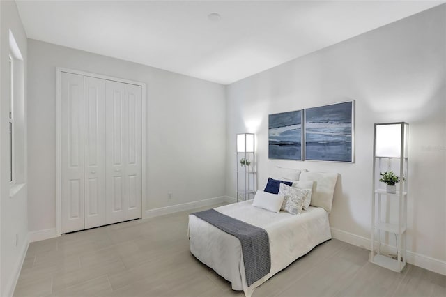 bedroom featuring a closet and baseboards