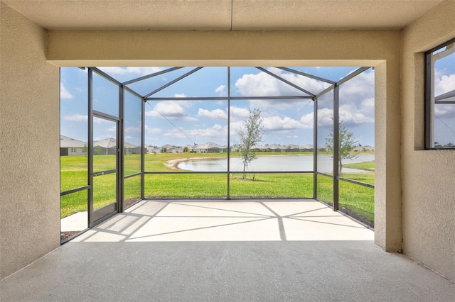 unfurnished sunroom with a water view and a residential view