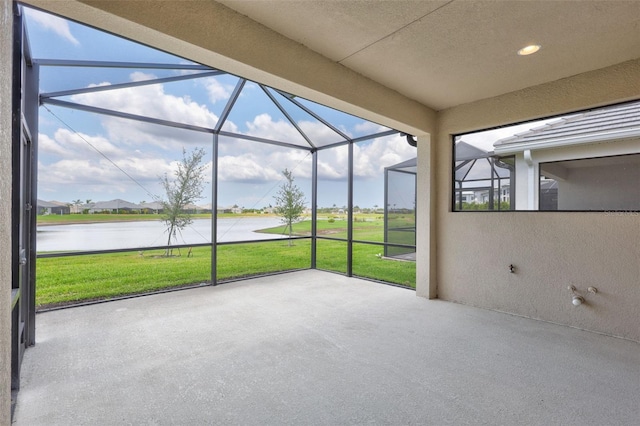 unfurnished sunroom with a water view