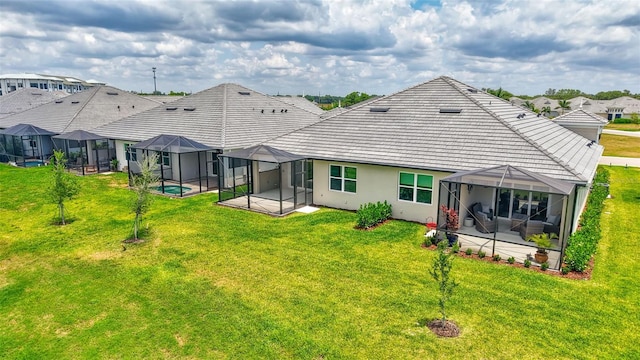 rear view of property featuring a patio, a lawn, and a residential view