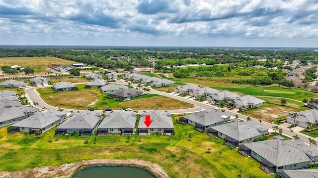 aerial perspective of suburban area with a large body of water and a golf club