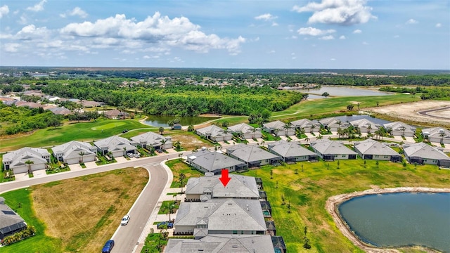 aerial view of residential area featuring a large body of water and a golf club