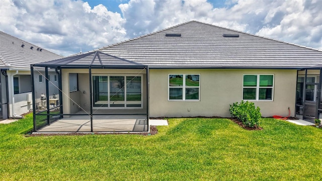 back of property featuring stucco siding, a patio area, and a lawn