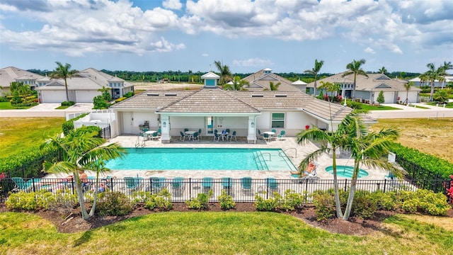 community pool with a residential view and a patio
