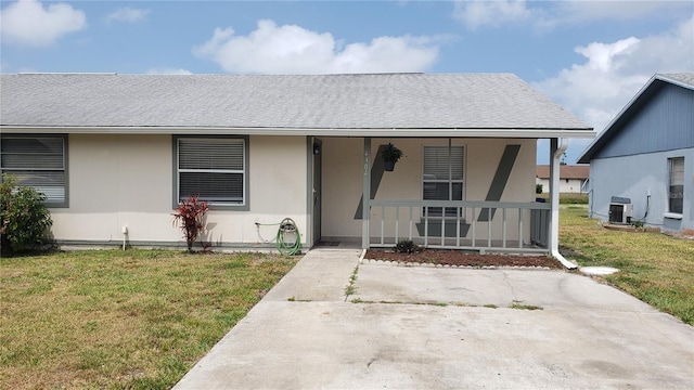 4304 78th St W Unit 4304, Bradenton, FL 34209 - bungalow-style home with a porch, a front yard, central AC, roof with shingles, and stucco siding