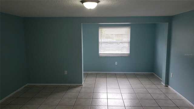 4304 78th St W Unit 4304, Bradenton, FL 34209 - spare room with a textured ceiling, tile patterned flooring, and baseboards
