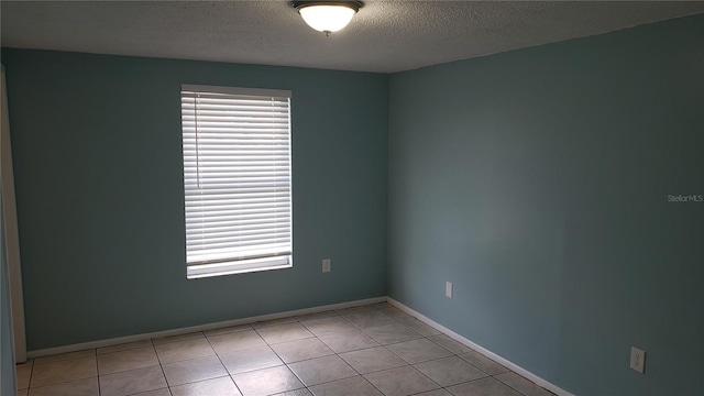 4304 78th St W Unit 4304, Bradenton, FL 34209 - empty room featuring a textured ceiling, light tile patterned floors, and baseboards