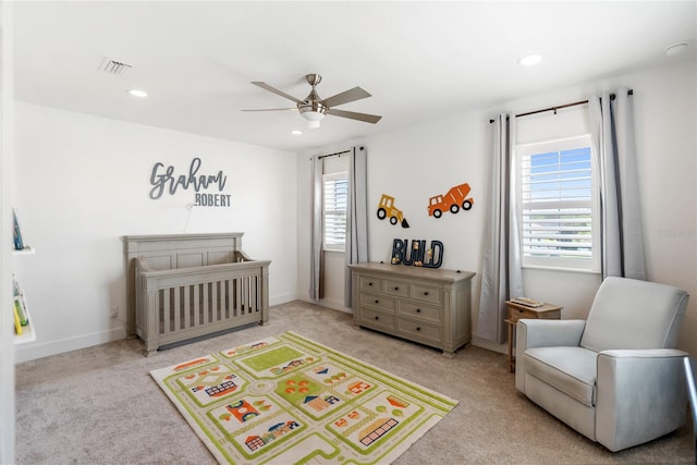 carpeted bedroom featuring multiple windows, a nursery area, recessed lighting, ceiling fan, and baseboards