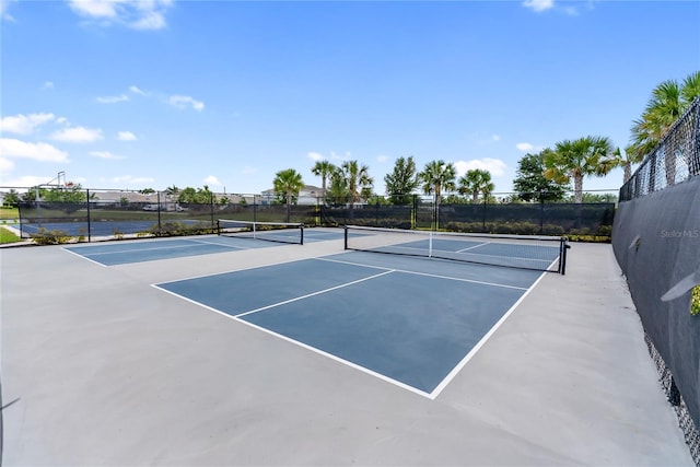 view of tennis court with fence and community basketball court