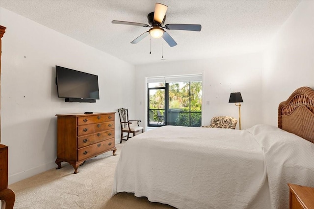 1629 Pelican Cove Rd Unit 138A, Sarasota, FL 34231 - bedroom with light carpet, access to outside, ceiling fan, baseboards, and a textured ceiling