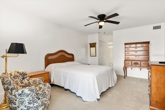 1629 Pelican Cove Rd Unit 138A, Sarasota, FL 34231 - bedroom featuring light colored carpet, connected bathroom, and a ceiling fan