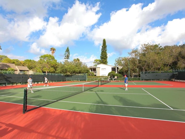1629 Pelican Cove Rd Unit 138A, Sarasota, FL 34231 - view of tennis court with community basketball court and fence