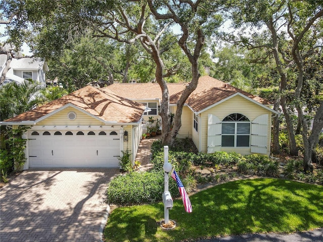 6402 23rd Avenue Dr W, Bradenton, FL 34209 - view of front of home with decorative driveway, an attached garage, and a front yard