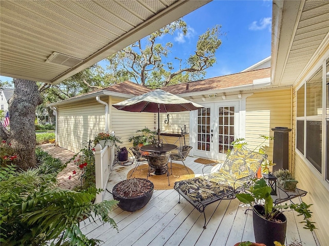 6402 23rd Avenue Dr W, Bradenton, FL 34209 - wooden terrace with french doors and outdoor dining space