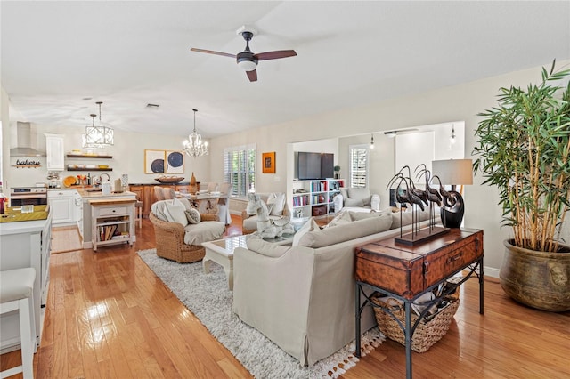 6402 23rd Avenue Dr W, Bradenton, FL 34209 - living area featuring light wood-style flooring, ceiling fan, and a chandelier